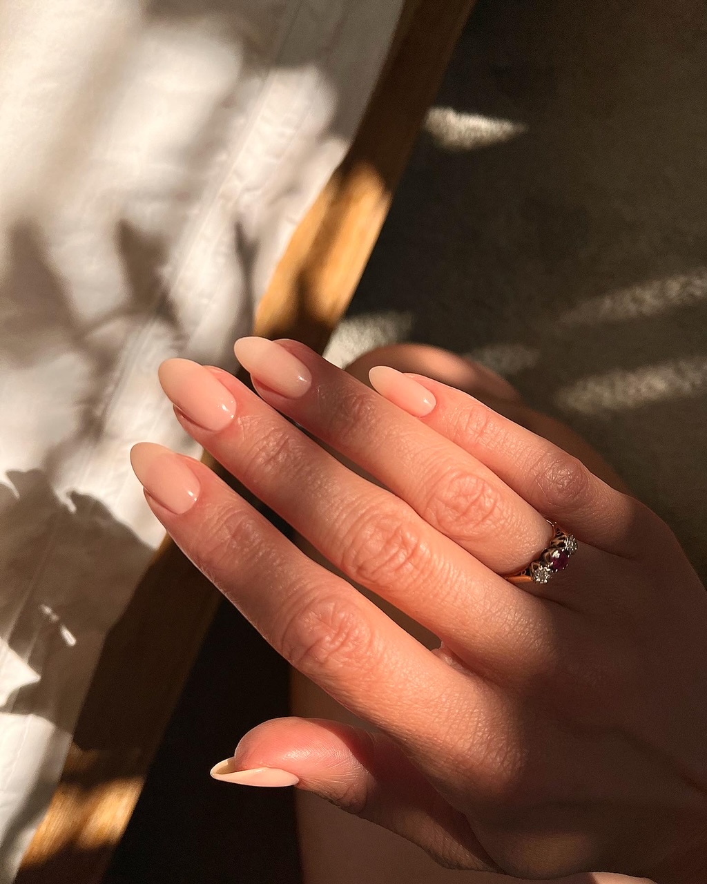 Sheer nude nails in an almond shape